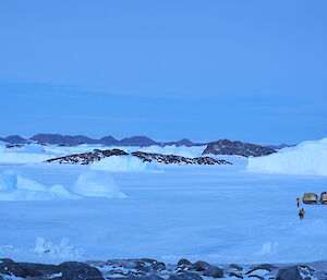 The view from the top of the hill near Mikkelsens Cairn with the Hagg and expeditioners on the sea ice in the foreground