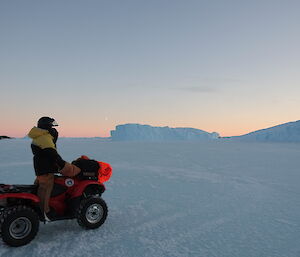 Jen Proudfoot looks ahead over the sea-ice on one of the recovered Quads on the way back to Davis