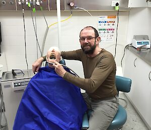 John Parker the doctor at Davis practices his dental skills on the dental dummy Oric
