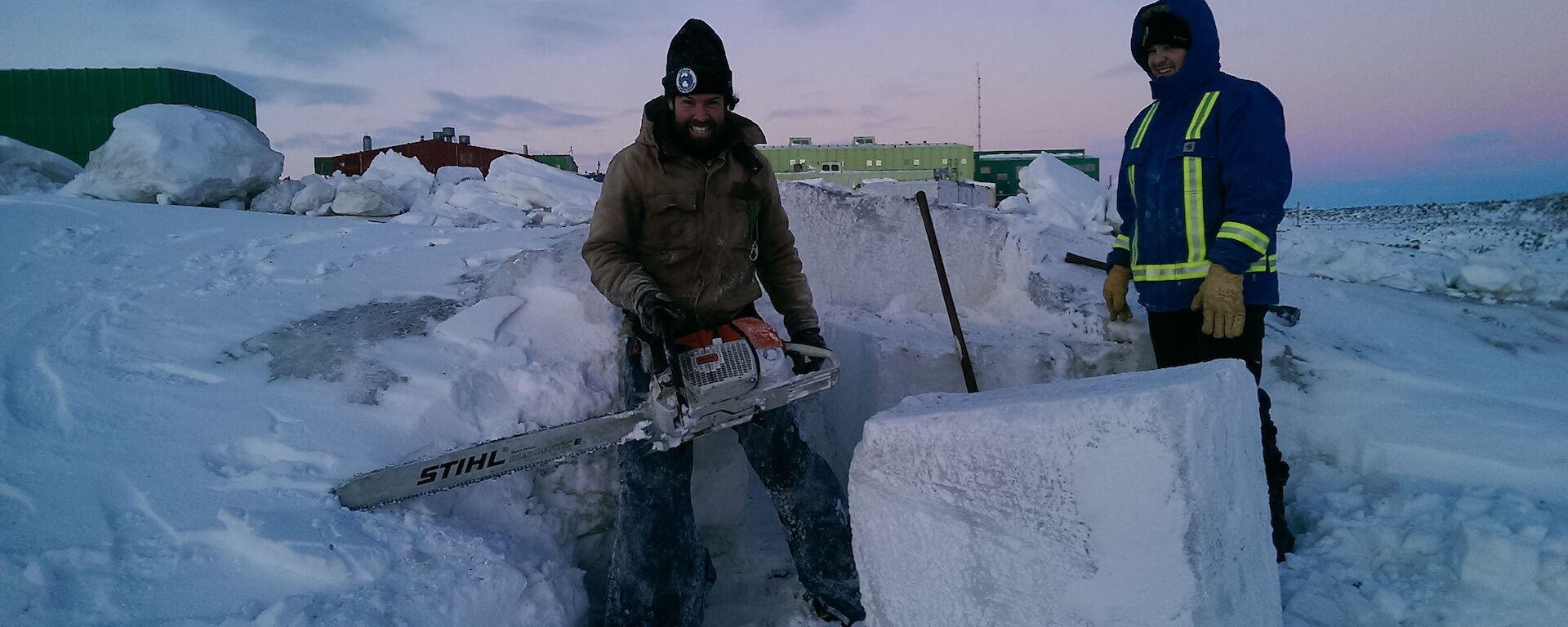 Chris Burns and Vas Georgiou cutting ice with a chainsaw