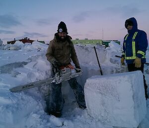 Chris Burns and Vas Georgiou cutting ice with a chainsaw