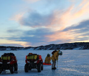 A field party drills the sea ice to ascertain thickness on the way to Platcha hut in the Vestfold Hills