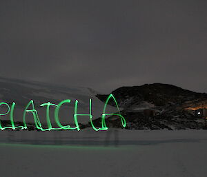 Platcha written in the night sky using glow sticks and a long exposure