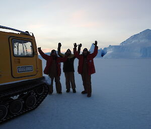 John Parker, Darren White and Craig Butsch pose in front of a deep blue iceberg cave