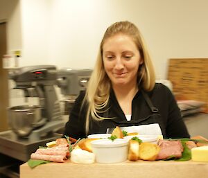 Jen Proudfoot carries the buffet platter to the servery at Davis for Midwinter brunch