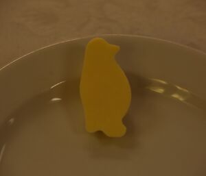 A butter penguin on a plate set for Midwinter brunch at Davis