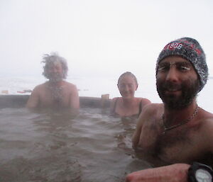 Chris Burns, Paul Bright, and Jen Proudfoot relax in the spa on Midwinters Day at Davis