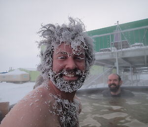 Chris Burns covered in ice in the outdoor spa at Davis for Midwinter