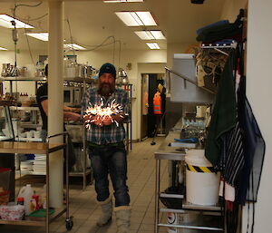 Darren White with sparklers ahead of the birthday cake being delivered to Paul Deverall on his birthday at Davis this week