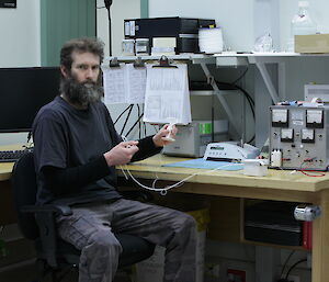 Craig Butsch preparing a radiosonde to tie to the weather balloon by reinforcing with thicker string