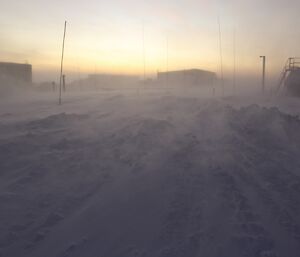 Snow blowing through station as the winds lessen after a blizzard at Davis