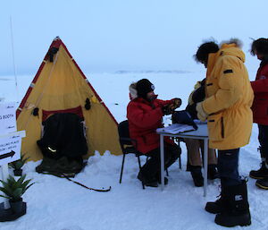 Voters at Davis are handed their papers by the Antarctic Returning Officer and his assistant