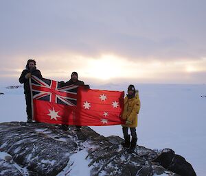 Scott, Aaron and Chris with Sir Hubert Wilkins flag at Walkabout Rocks in the Vestfold Hills