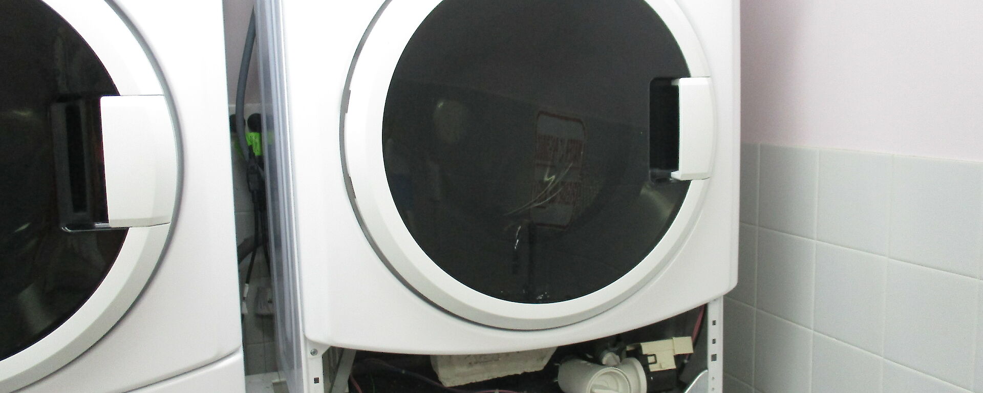 A broken washing machine in the SMQ laundry at Davis