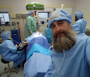 Several Davis expeditioners in the operating theatre learning about the instruments