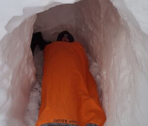 Darren White inside his cave wrapped up warm in his sleeping bag and bivy