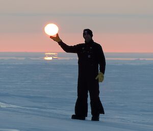 An photo that looks like the moon is being held in the palm of a hand