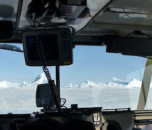 A view of icebergs and sea ice on a sunny day out of the window of a Hägglunds