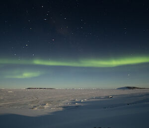 The moon highlighting Prydz Bay with aurora