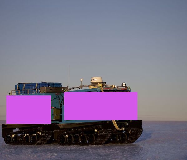 A picture of a Hägglunds painted pink to illustrate what a pink Hagg might look like. This one is depicted on the blue ice of the East Antarctic ice sheet to the south of Davis.