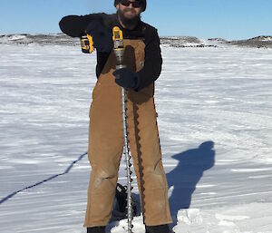Dr John Parker on the sea ice at Davis preparing to drill the thickness at one of the sea ice monitoring localities