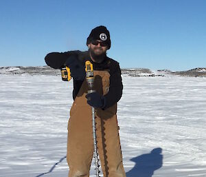 Dr John Parker on the sea ice at Davis preparing to drill the thickness at one of the sea ice monitoring localities