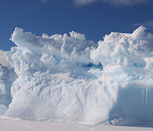 A picture of a blue iceberg, which are like snow flakes as no two are alike