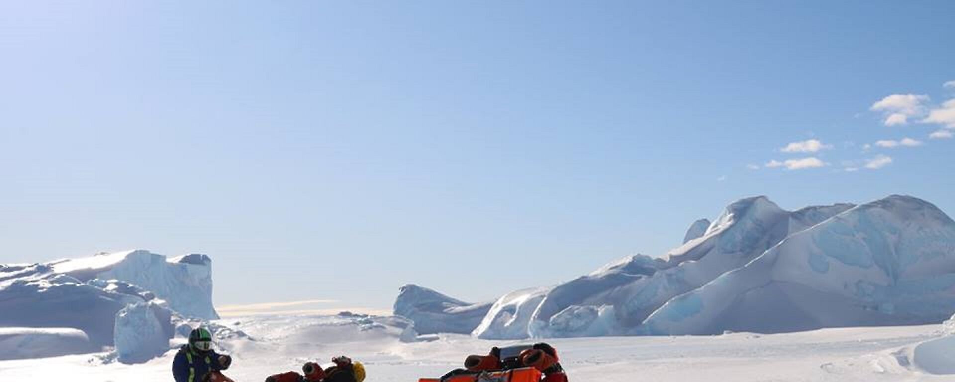 An expeditioner with two quad bikes on the sea ice