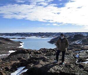 The expeditioner Paul Deverall on top of Boulder Hill with Crooked Lake in the background