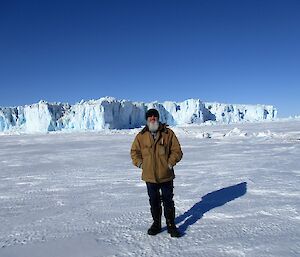 The expeditioner Paul Deverall on the sea ice with the Sørsdal Glacier in thee background