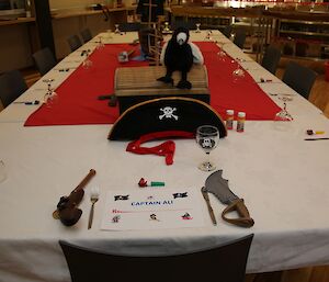 A birthday place setting at the table for Ali with pirate hat, pistol and eye patch