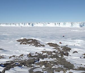 A picture of a very big glacier called Sørsdal Glacier with quad bikes in the foreground