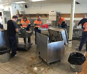 The team cleaning the ovens and brat pan in the Davis kitchen