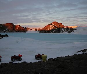 A sunset at Platcha hut, the Vestfold hills and ice plateau, quad bikes in the foreground