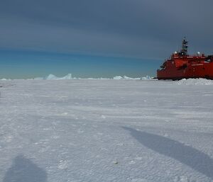 A view of the ship with the fuel line snaking over the sea ice ready for refuelling