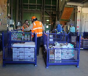 People unpacking crates of supplies in the Greenstore