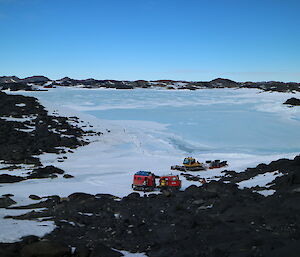 A Hägglunds and groomer in an icy landscape.