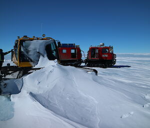 Groomer buried in a snow drift