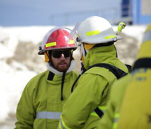 Darren and Jock are in full fire fighting equipment. Jock has his breathing apparatus on as he is about to go into the building used for the fire drill.