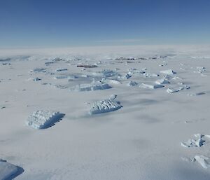 This is an aerial view of the icebergs trapped in the frozen ocean. Beyond them you can see the plateau from which they calved from.