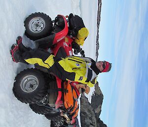 Barry is looking happy, leaning against his quad bike, while admiring the view.