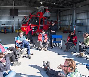 Expeditioners sitting around in a circle, relaxing on a Friday afternoon.
