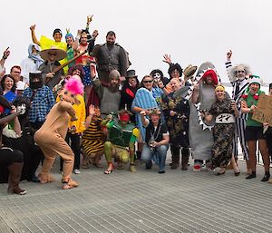 Group photo of everyone dressed up, standing out on the deck.