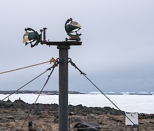 Two sunshine recording devices, on a pole, held upright by gyropes.