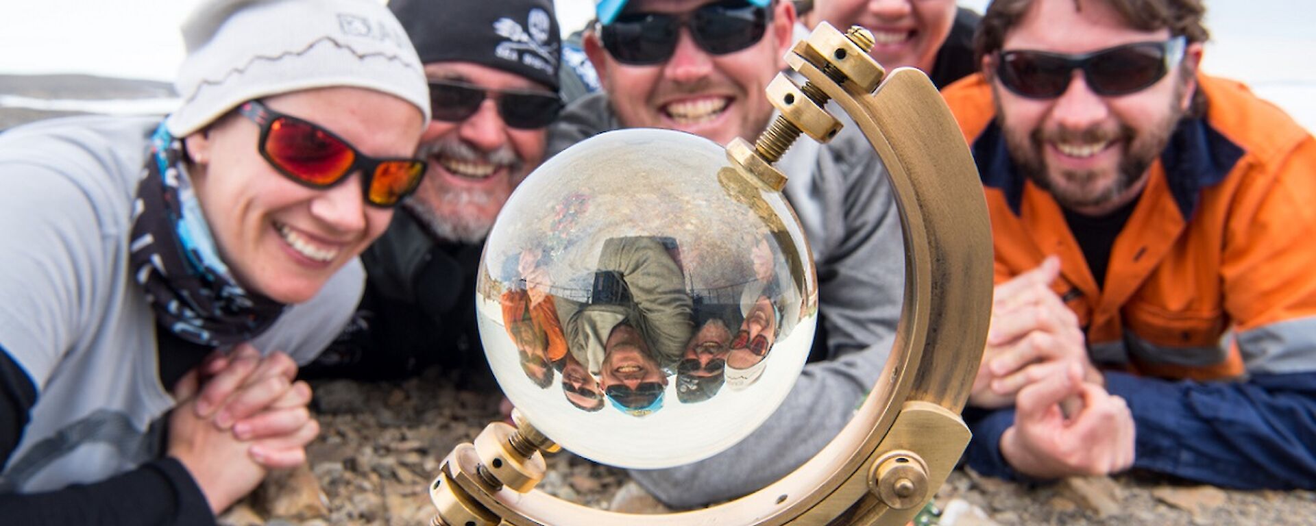 Daleen, Barry, Damo, Rachel and Aaron are lying in a half circle, on the ground, looking at the sunshine recorder. This device looks like a hybrid between a sextant and a crystal ball.
