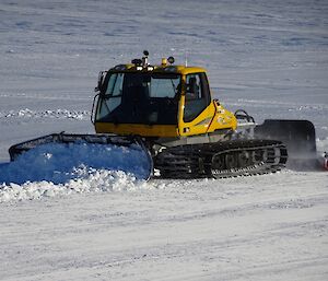Ross is clearing snow with a groomer, in order to make a runway where planes can land