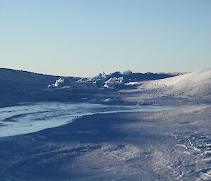 A mix of rough ice from the glacier and smooth ice from the melt pool, inside a collapsed feature on the glacier surface.