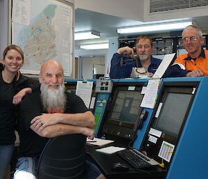 The comms and IT crew pose around the comms panel: Sam, Mick, Dave D., Robert and Dave P.