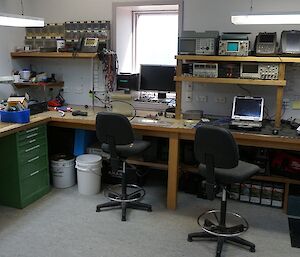 The comms workshop, full of tools and spare parts for fixing various electronic equipment on station.