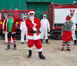 Father Christmas poses for the camera, with his reindeer and the Hagglund vehicle.